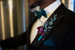 Groom suit bow tie teal boutonniere hellebore