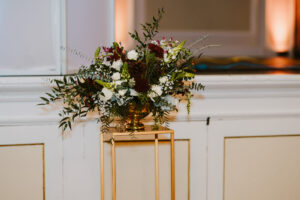 Winter Wedding Ceremony arrangement pine cones compote green red white